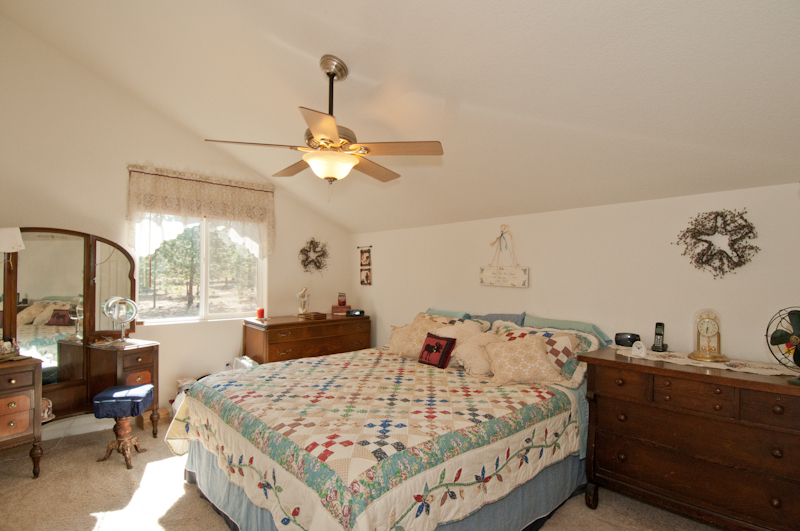10672 Ridgetop Road Whitmore, CA 96096 - Photo 12 of 20 a bed room with a bed mirror and a window