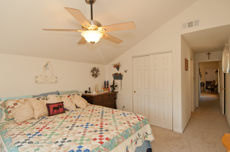 10672 Ridgetop Road Whitmore, CA 96096 - Photo 13 of 20 a bedroom with a bed and a chandelier