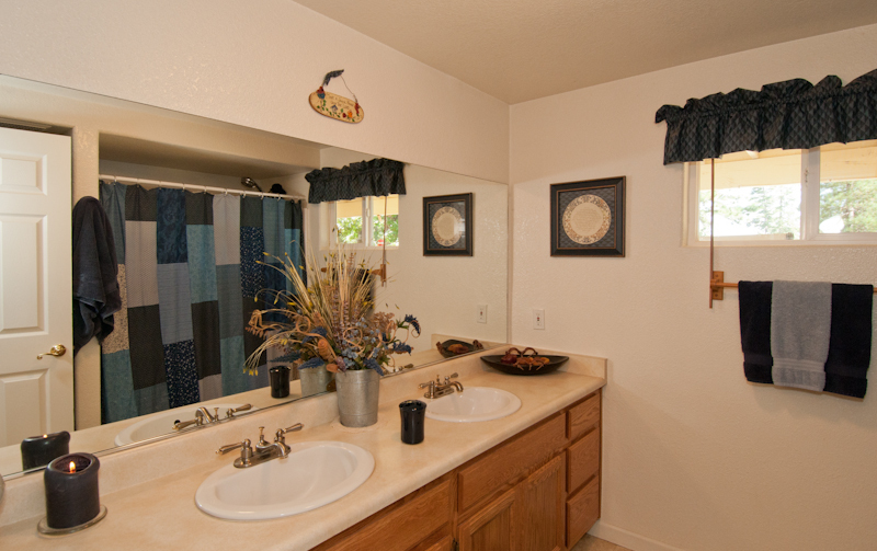 10672 Ridgetop Road Whitmore, CA 96096 - Photo 15 of 20 a bathroom with a double vanity sink and a mirror