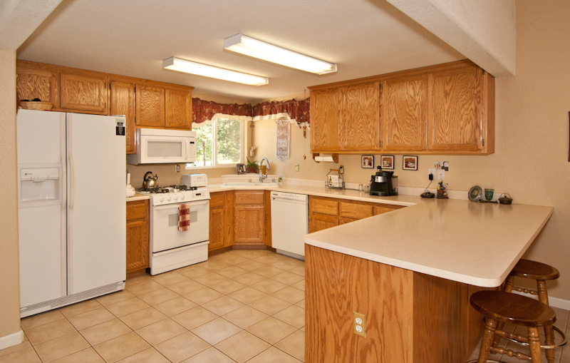 10672 Ridgetop Road Whitmore, CA 96096 - Photo 9 of 20 a kitchen with white cabinets and white appliances