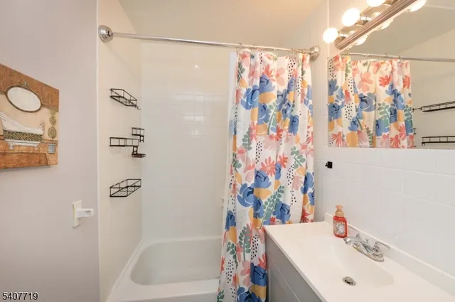 a bathroom with a sink and a shower curtain