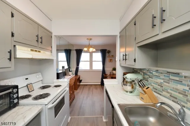 a kitchen with a stove a sink and cabinets