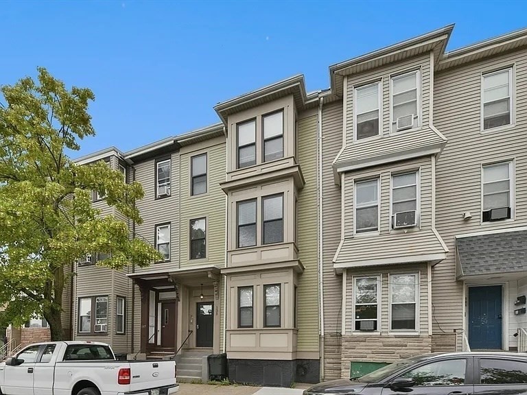 135 Havre Street, Unit 4 Boston, MA 02128 - Photo 2 of 4 a front view of a residential apartment building with a yard