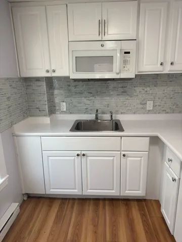 a kitchen with stainless steel appliances granite countertop a sink a microwave and cabinets