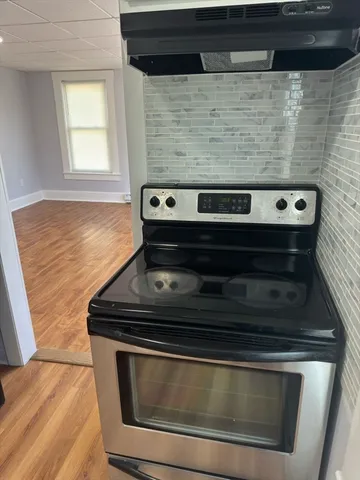 a stove top oven sitting inside of a kitchen