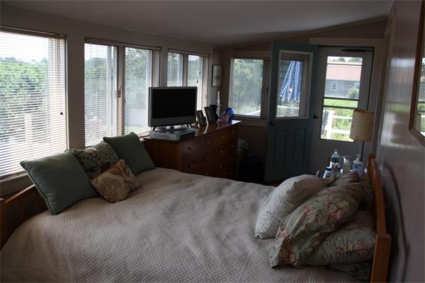 14 Clark Road Ipswich, MA 01938 - Photo 11 of 12 a bedroom with a bed and large windows