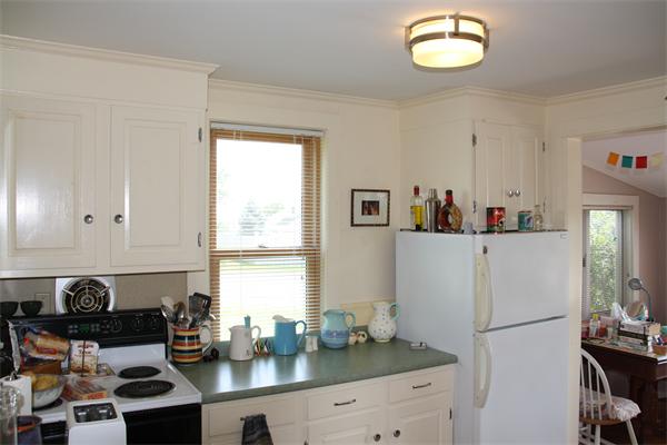 14 Clark Road Ipswich, MA 01938 - Photo 8 of 12 a kitchen with a refrigerator and a stove top oven