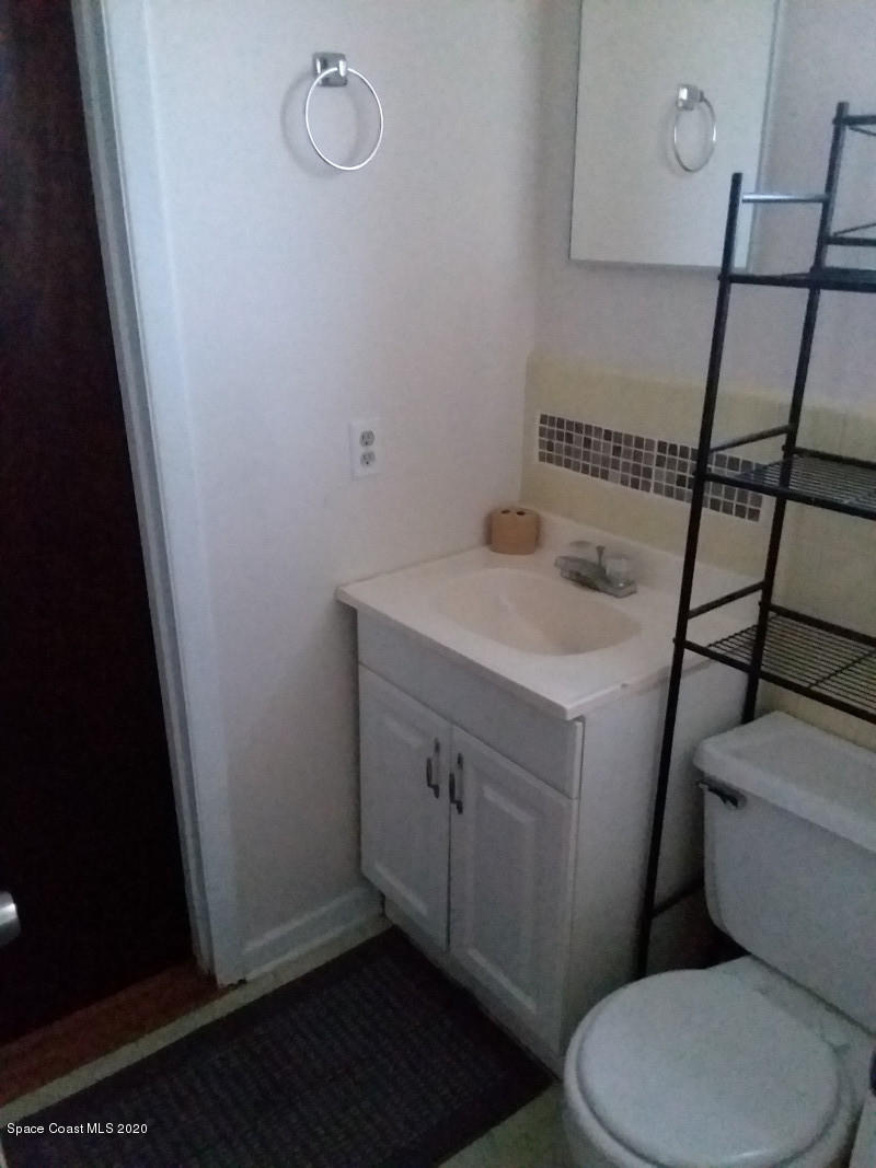 1030 Hibiscus Street Cocoa, FL 32927 - Photo 6 of 6 a bathroom with a sink a toilet and vanity