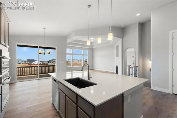 a kitchen with stainless steel appliances a kitchen island a stove a table and chairs