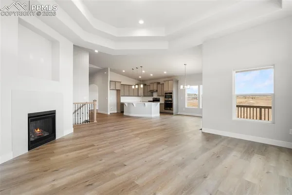 a view of a living room a kitchen with furniture and fireplace