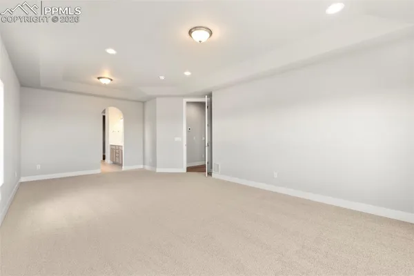 an empty room with window and pillar in it