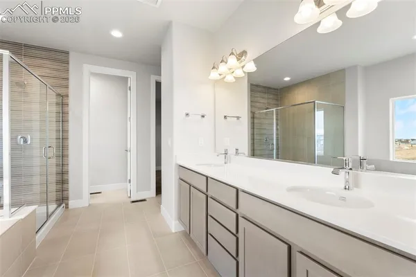 a spacious bathroom with a double vanity sink mirror and shower