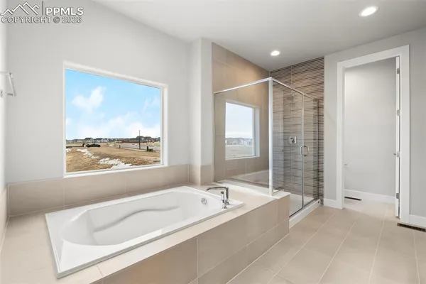 a spacious bathroom with a tub and shower