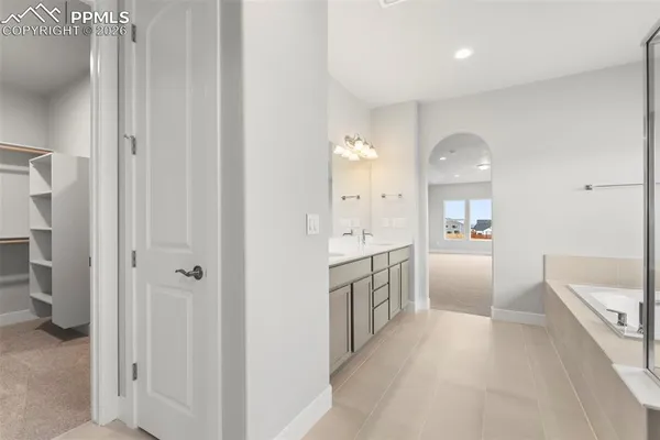 a large bathroom with a glass door shower a sink and a mirror
