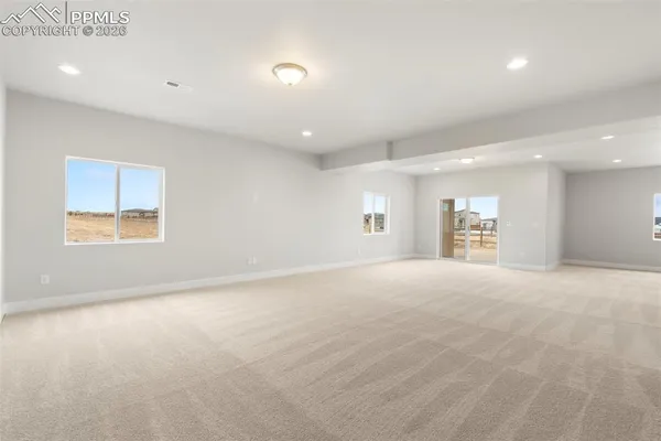 a view of empty room with a fireplace