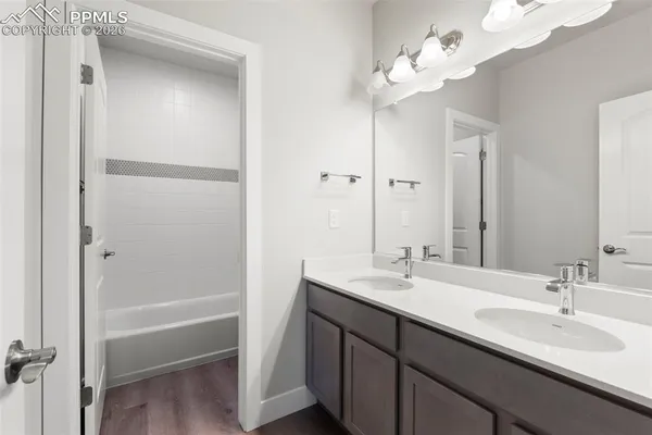 a bathroom with a double vanity sink and a mirror