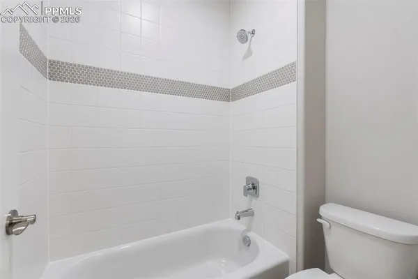 a bathroom with a bathtub and a toilet