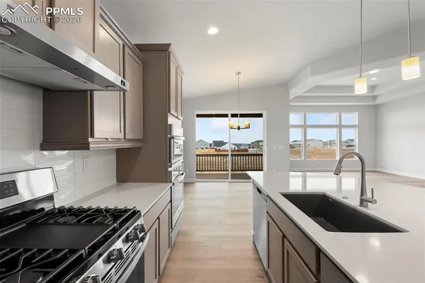 a kitchen with granite countertop a stove and a sink