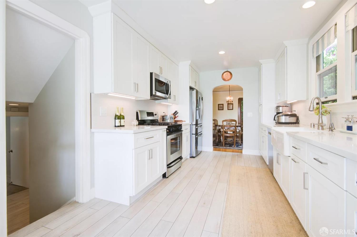 3231 Fernside Boulevard Alameda, CA 94501 - Photo 12 of 38 a large kitchen with cabinets wooden floor and stainless steel appliances