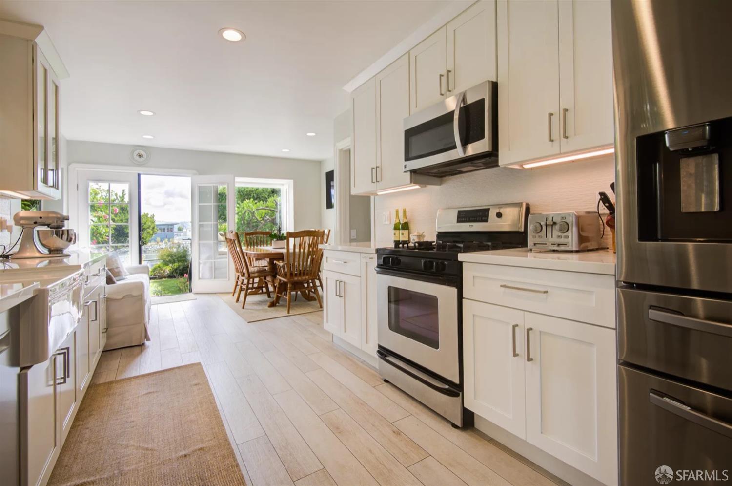 3231 Fernside Boulevard Alameda, CA 94501 - Photo 14 of 38 a kitchen with stainless steel appliances a stove sink microwave and cabinets