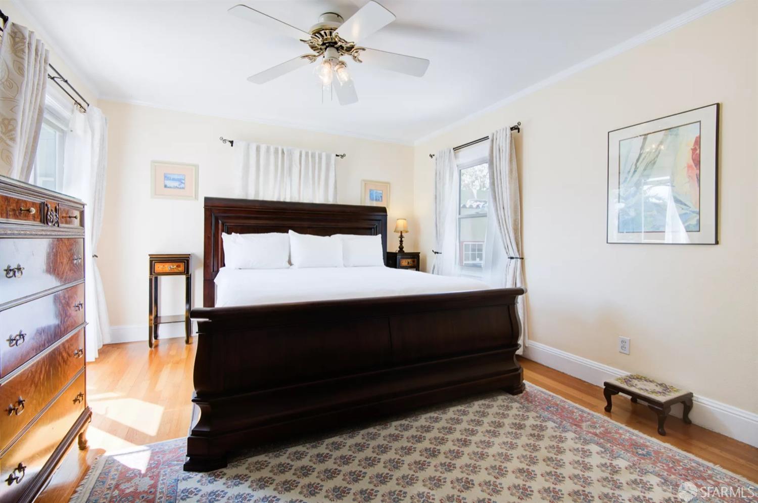 3231 Fernside Boulevard Alameda, CA 94501 - Photo 15 of 38 a bedroom with a bed and a chandelier
