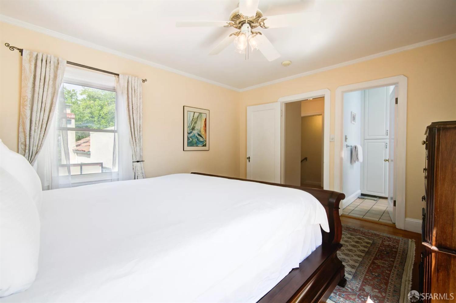 3231 Fernside Boulevard Alameda, CA 94501 - Photo 17 of 38 a spacious bedroom with a bed and a chandelier