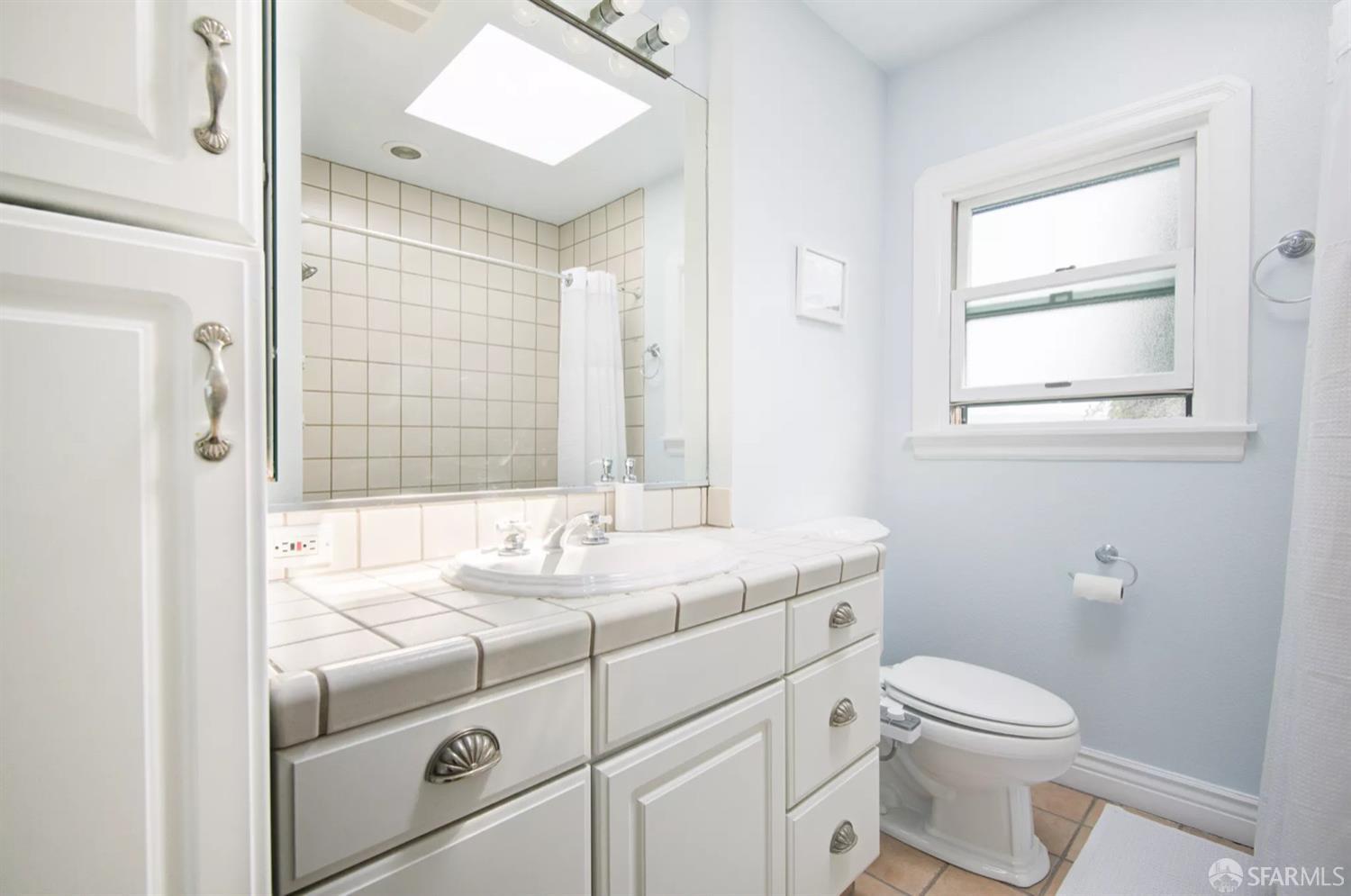 3231 Fernside Boulevard Alameda, CA 94501 - Photo 18 of 38 a bathroom with a sink toilet vanity and window