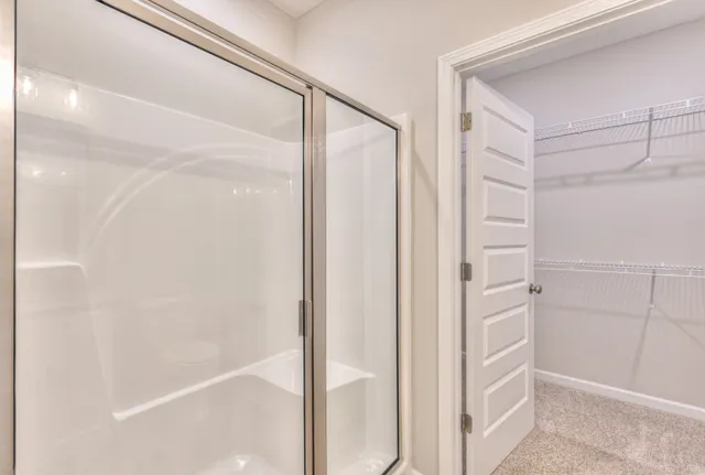 a bathroom with a glass shower door