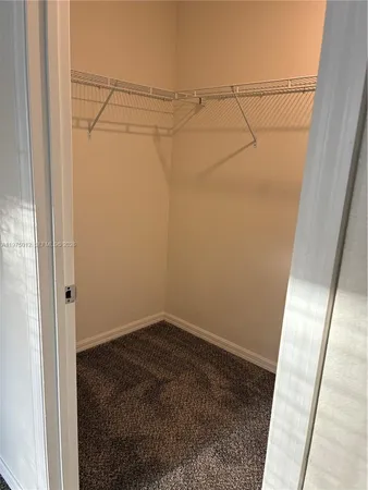 a bathroom with a granite countertop sink and a toilet
