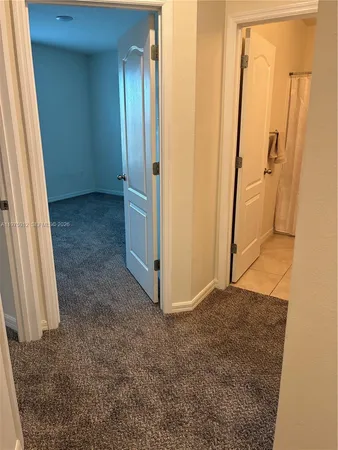 a bathroom with a granite countertop sink a toilet and mirror