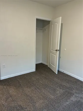 a room with water heater and wooden cabinets