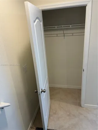 a kitchen with kitchen island sink and wooden floor