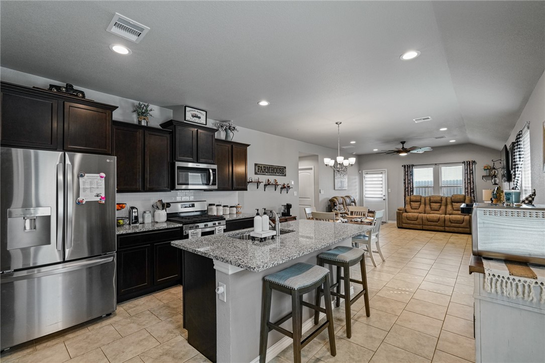 7618 Herd Rider Corpus Christi, TX 78414 - Photo 3 of 14 a kitchen with refrigerator and chairs