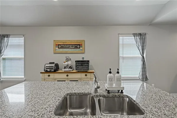 a kitchen with sink cabinets and window