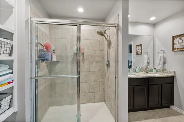 a bathroom with a mirror sink and shower