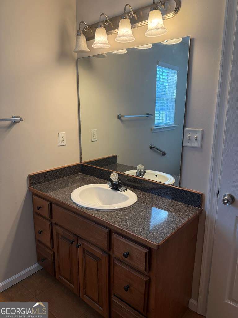 3749 Old Pine Road Valdosta, GA 31605 - Photo 14 of 24 a bathroom with a sink and a mirror