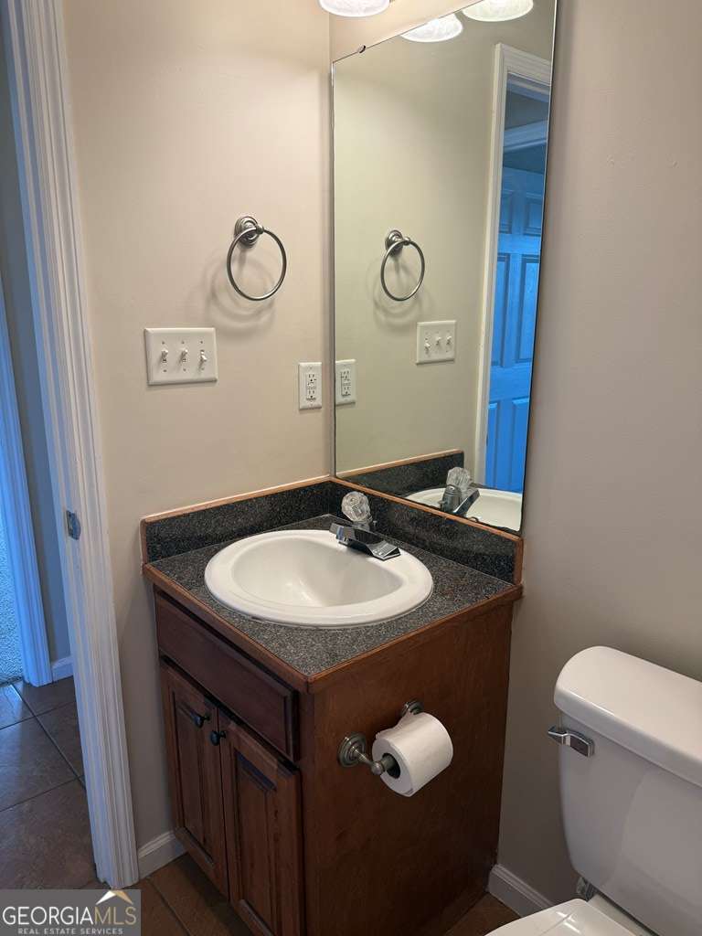 3749 Old Pine Road Valdosta, GA 31605 - Photo 18 of 24 a bathroom with a granite countertop toilet sink and mirror