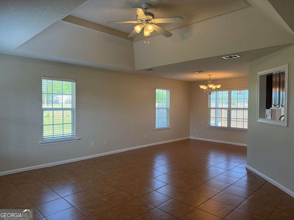 3749 Old Pine Road Valdosta, GA 31605 - Photo 2 of 24 a view of an empty room with window and chandelier fan