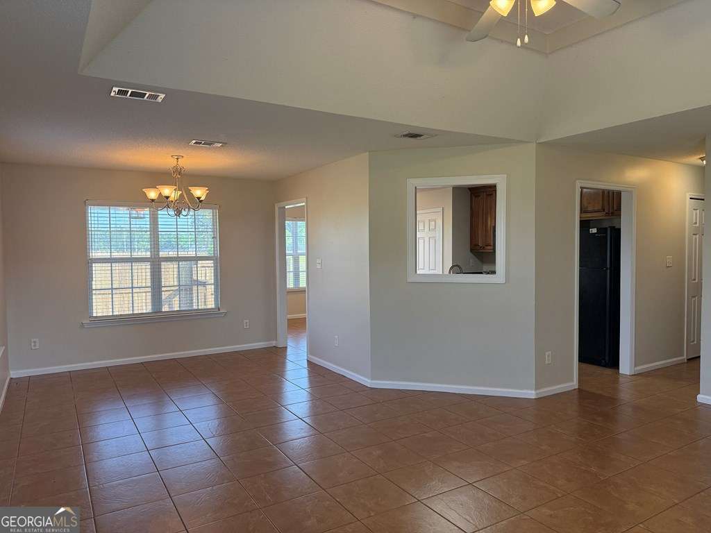 3749 Old Pine Road Valdosta, GA 31605 - Photo 5 of 24 a view of an empty room with window and wooden floor