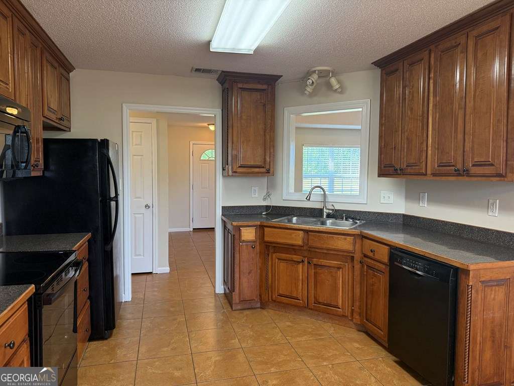 3749 Old Pine Road Valdosta, GA 31605 - Photo 8 of 24 a kitchen with stainless steel appliances granite countertop a refrigerator and a sink