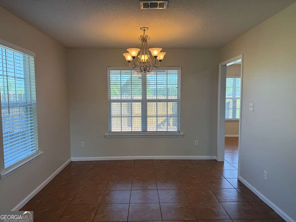 3749 Old Pine Road Valdosta, GA 31605 - Photo 10 of 24 wooden floor in an empty room with a window