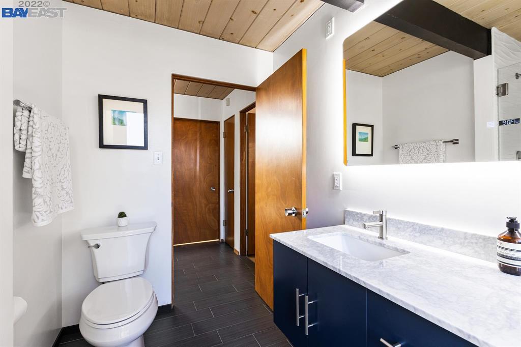 252 Clyde Drive Walnut Creek, CA 94598 - Photo 22 of 57 a bathroom with a granite countertop sink toilet and shower