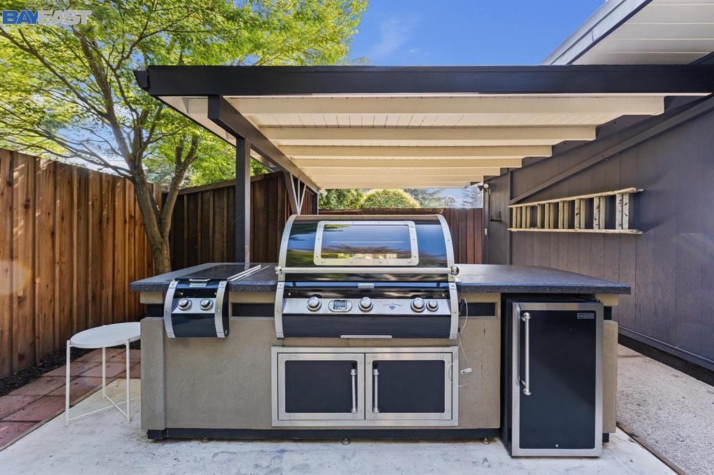 252 Clyde Drive Walnut Creek, CA 94598 - Photo 52 of 57 a living room with stainless steel appliances kitchen island a stove and a microwave