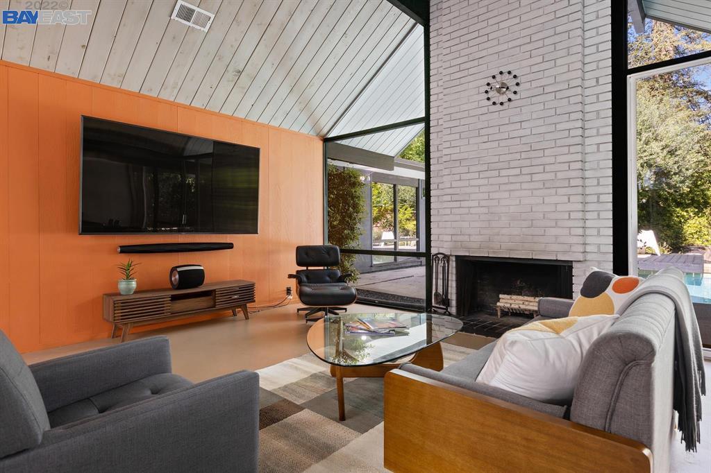 252 Clyde Drive Walnut Creek, CA 94598 - Photo 7 of 57 a living room with furniture a flat screen tv and a fireplace