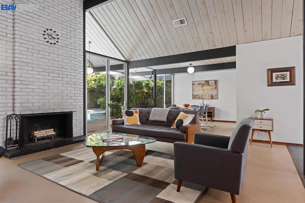 252 Clyde Drive Walnut Creek, CA 94598 - Photo 8 of 57 a living room with furniture a fireplace and a table