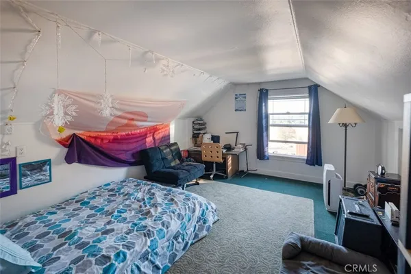 a bedroom with furniture and a window