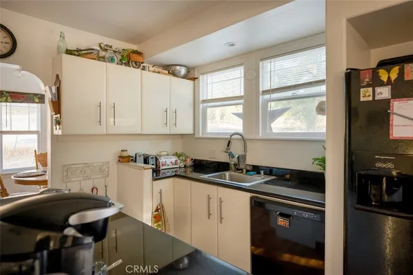 a kitchen with granite countertop a sink stove and cabinets