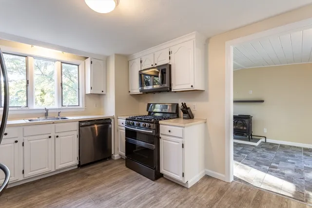 a kitchen with stainless steel appliances granite countertop a stove and a sink