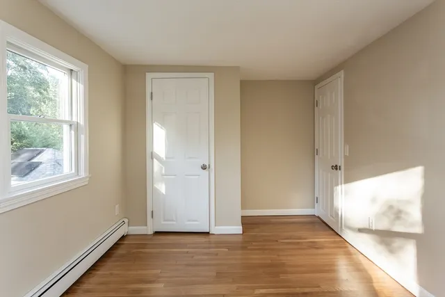 a spacious bathroom with a granite countertop sink a toilet and mirror