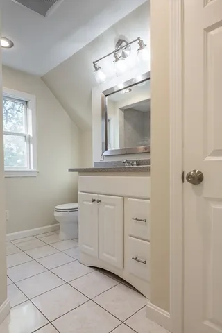 a bathroom with a granite countertop sink a shower and mirror